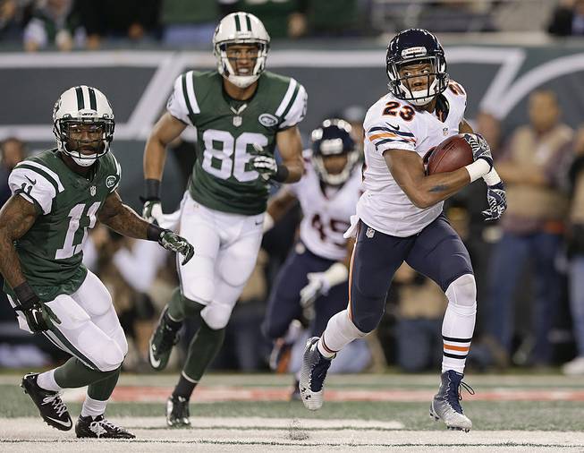 Chicago Bears cornerback Kyle Fuller (23) is pursued by New York Jets wide receiver Jeremy Kerley (11) and wide receiver David Nelson (86) after intercepting a pass in the end zone during the third quarter of an NFL football game, Monday, Sept. 22, 2014, in East Rutherford, N.J.