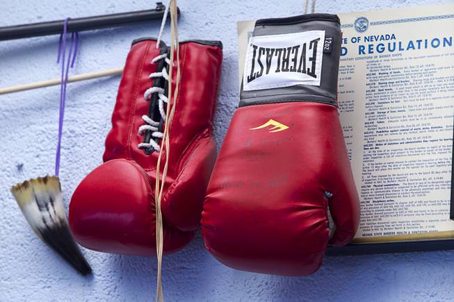 Boxing gloves signed by boxer Marcos Maidana hand on a wall at Geraldo's Classic Barber Shop, 3869 Spring Mountain Rd., Sunday Sept. 21, 2014.
