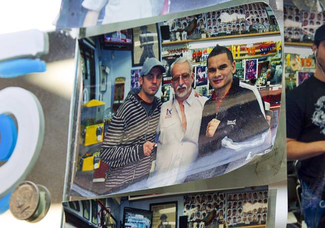 A photos showing Geraldo Carranza, center, and boxer Marcos Maidana, right, of Argentina at Geraldo's Classic Barber Shop, 3869 Spring Mountain Rd., Sunday Sept. 21, 2014.