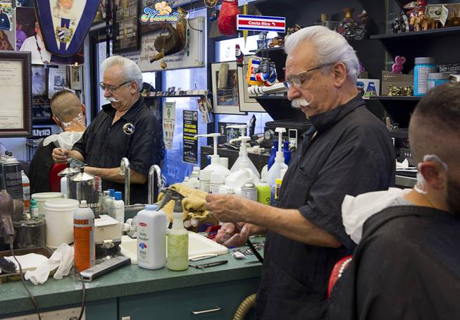 Geraldo Carranza gives a haircut to Peter Apostolov at Geraldo's Classic Barber Shop, 3869 Spring Mountain Rd., Sunday Sept. 21, 2014.