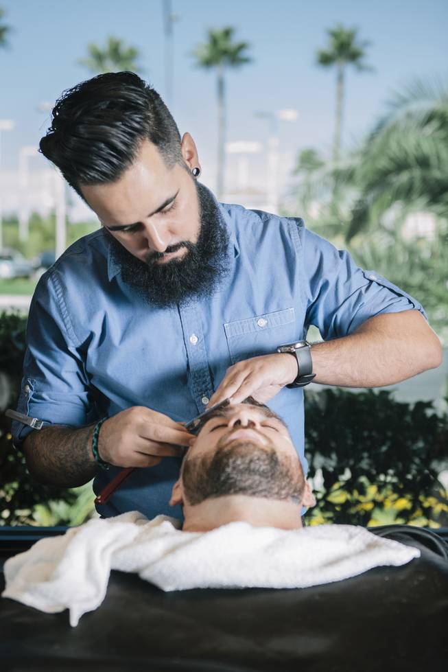 Tim Avalos cuts Phil Baroni's hair at Fino for Men in Las Vegas, Nev. on September 20, 2014.