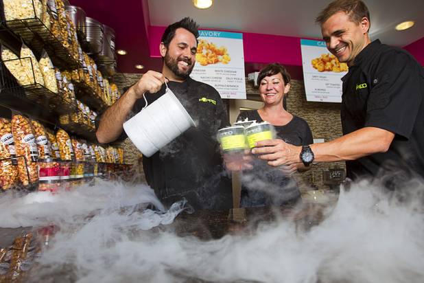 Owners Oliver Morowati, left, Zelma Hulet, center, and Jean-Francois Chavanel make frozen popcorn at Popped, a gourmet popcorn shop at 3700 S. Hualapai Way, Wednesday Sept. 24, 2014. The shop blasts popcorn with liquid nitrogen (-321F) to create a frozen popcorn dessert.