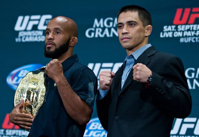 Flyweight fighters Demetrious Johnson and Chris Cariaso together after facing off during UFC 178 media day at the MGM Grand Arena on Thursday, September 25, 2014. .