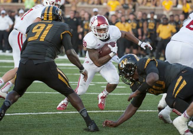 Indiana running back D'Angelo Roberts, center, splits Missouri defenders Charles Harris, left, and Sean Culkin during the fourth quarter of an NCAA college football game Saturday, Sept. 20, 2014, in Columbia, Mo. Indiana upset Missouri 31-27. (AP Photo/L.G. Patterson)