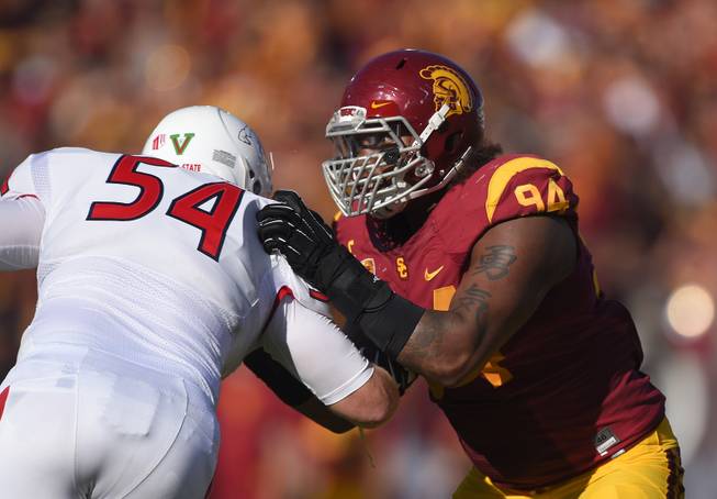 Southern California defensive end Leonard Williams, right, battles with Fresno State offensive linesman Justin Northern during the first half of an NCAA college football game, Saturday, Aug. 30, 2014, in Los Angeles. (AP Photo/Mark J. Terrill)