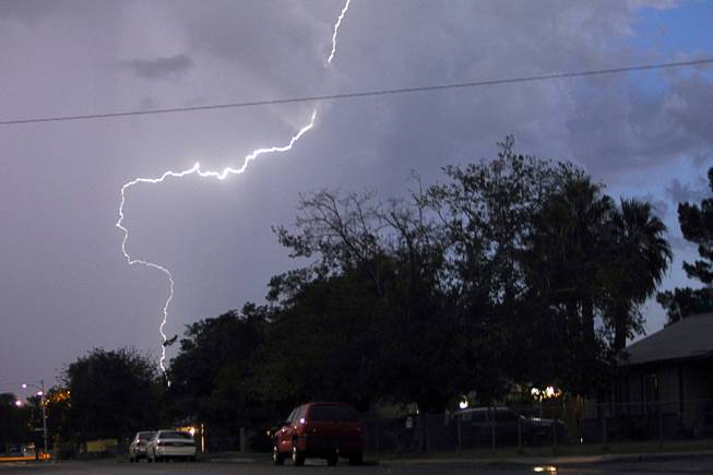 Lightning strikes over a neighborhood near Charleston  and Decatur boulevards during a rainstorm Friday evening, Sept. 26, 2014.  