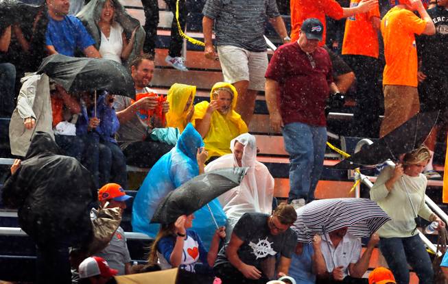 Bishop Gorman fans begin to take cover from a rain storm moving into the area delaying the game versus St. John Bosco on Friday, September 26, 2014.