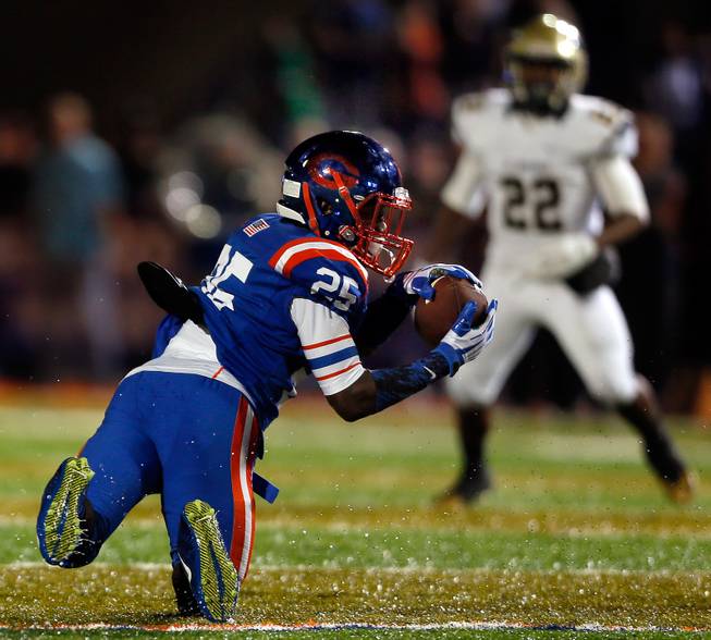 Bishop Gorman's Tyjon Lindsey #25 goes to a knee to make a catch during the game versus St. John Bosco on Friday, September 26, 2014.