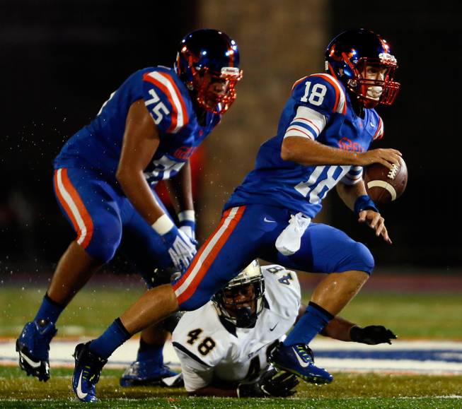 Bishop Gorman's QB Tate Martell #18 scrambles from the pocket looking for a receiver during the game versus St. John Bosco on Friday, September 26, 2014.