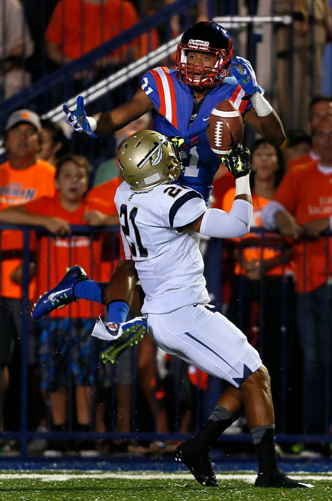 Bishop Gorman's Cordell Broadus #21 and St. John Bosco's Mykal Tolliver #21battle for a long pass during their game on Friday, September 26, 2014.