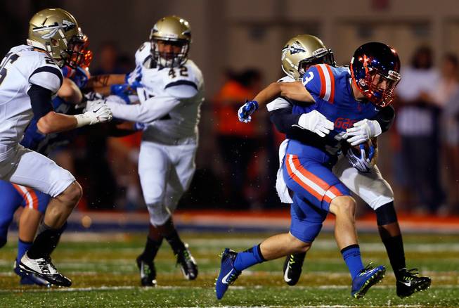 Bishop Gorman's Brandon Gahagan #3 works to fight off a tackle in the St. John Bosco secondary on Friday, September 26, 2014.