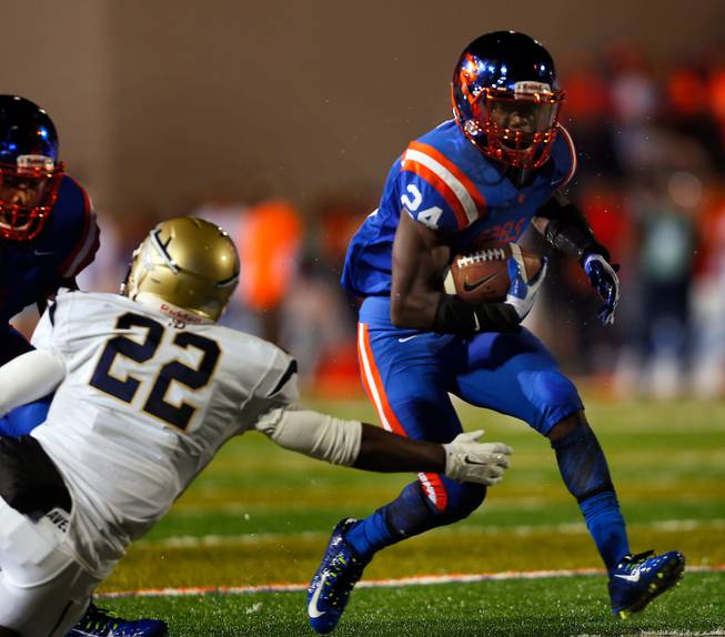 Bishop Gorman's Russell Booze #24 breaks another St. John Bosco tackle headed for the end zone on Friday, September 26, 2014.