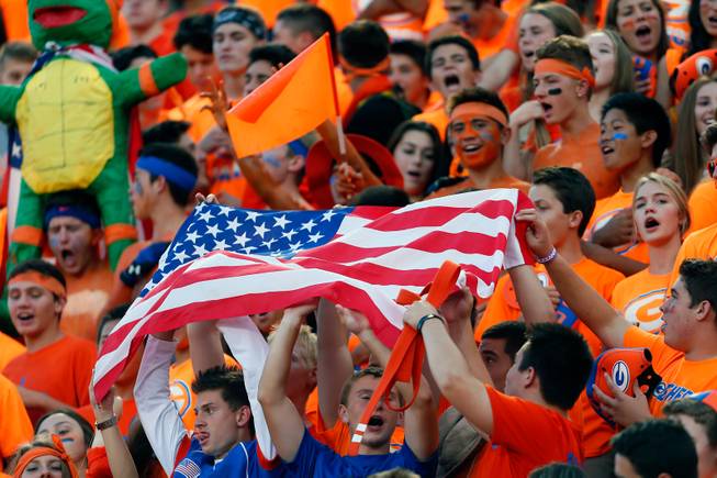 Bishop Gorman fans pass up the American flag during the National Anthem before kickoff for the game versus St. John Bosco on Friday, September 26, 2014.