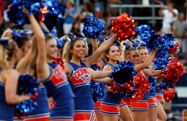 Bishop Gorman cheerleaders welcome the players and coaches to the field for their game versus St. John Bosco on Friday, September 26, 2014.