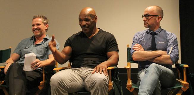 Mike Tyson is shown with writer Hugh Davidson, left, during the news conference and screening of the upcoming Adult Swim series "Mike Tyson Mysteries" at Warner Bros. Studios in Burbank, Calif., on Tuesday, Sept. 23, 2014.
