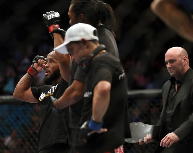 Flyweight title fighter Demetrious Johnson is announced the winner over Chris Cariaso as Dana White comes over with Johnson's belt, ending UFC 178 at the MGM Grand Garden Arena on Saturday, Sept. 27, 2014.