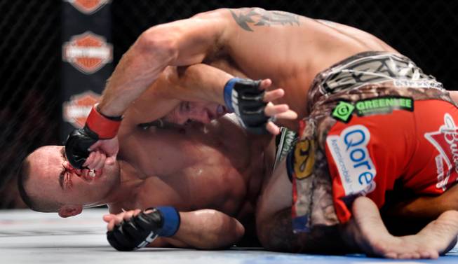 Lightweight fighter Donald Cerrone rsends another punch to the face of Eddie Alvarez who has had enough during UFC 178 at the MGM Grand Garden Arena on Saturday, September 27, 2014.