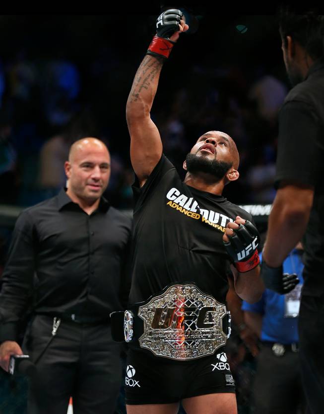 Flyweight title fighter Demetrious Johnson celebrates his win over Chris Cariaso as Joe Rogan looks on ending UFC 178 at the MGM Grand Arena on Saturday, September 27, 2014.