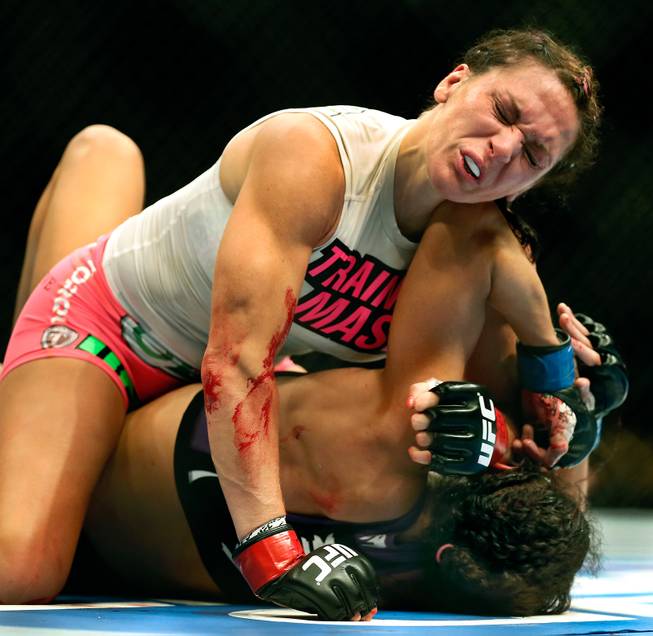 Women's Bantamweight fighter Cat Zingano drives an elbow to the face of opponent Amanda Nunes with one back at her during UFC 178 at the MGM Grand Garden Arena on Saturday, September 27, 2014.