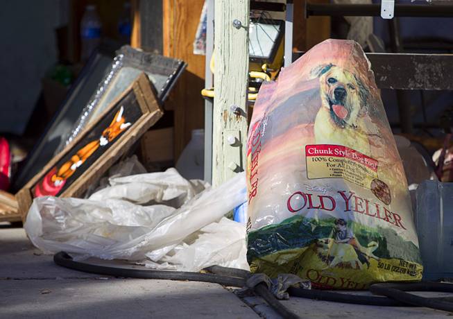 A bag of dog food is shown in the carport of a home owned by a North Las Vegas City Councilman Isaac Barron is shown on Stanley Avenue in North Las Vegas Monday Sept. 29, 2014. A fire on Sunday injured one man and killed 45 dogs in the home.