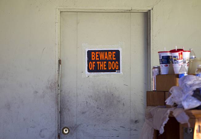 A sign is posted on the carport door of a home owned by a North Las Vegas City Councilman Isaac Barron is shown on Stanley Avenue in North Las Vegas Monday Sept. 29, 2014. A fire on Sunday injured one man and killed 45 dogs in the home.