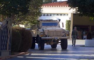 An armored vehicle leaves during an FBI raid at a home on Oquendo Road near Lamb Boulevard Monday Sept. 29, 2014.