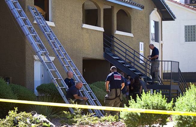 Henderson firefighters rest after a fatal apartment fire in Henderson Tuesday, Sept. 30, 2014. One man died in an upstairs unit after a fire started between the first and second floor, said Henderson Public Information Officer Kathleen Richards.