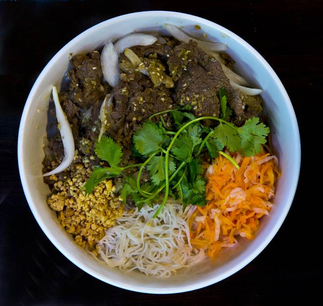 Nem Nuong Bistro features a Bun Bo Xao which is sliced beef with greens and peanuts over noodles on Thursday, September 25, 2014. L.E. Baskow.