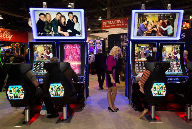 Attendees enjoy the new Friends show slot machines by Bally during the Global Gaming Expo (G2E) at the Sands Expo onTuesday, September 30, 2014.