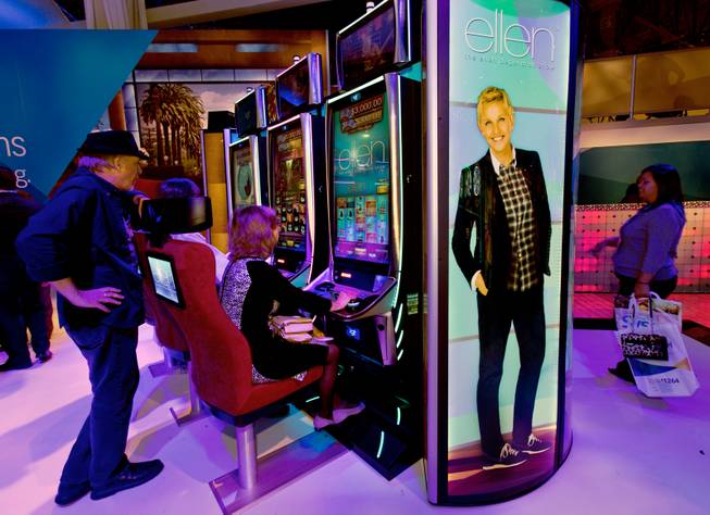 Attendees enjoy the new Ellen show slot machines by IGT during the Global Gaming Expo (G2E) at the Sands Expo onTuesday, September 30, 2014.