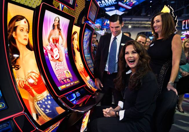 Lynda Carter laughs at winning right away on her new Wonder Woman slot machines unveiled during the Global Gaming Expo (G2E) at the Sands Expo onTuesday, September 30, 2014.
