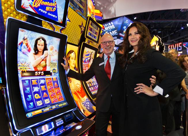 Bally Technologies CEO Richard Haddrill joins Lynda Carter about her new Wonder Woman slot machines being unveiled during the Global Gaming Expo (G2E) at the Sands Expo onTuesday, September 30, 2014.