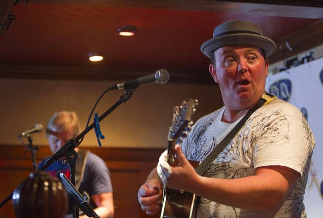 Dave Rooney, right, of The Black Donnellys performs during a kick-off for a Guinness World Record attempt in the Ri Ra Irish Pub at Mandalay Place Wednesday, Oct. 1, 2014. The pub is attempting to break the Guinness World Record for longest music marathon performed by Irish bands. The current record is 15 days.