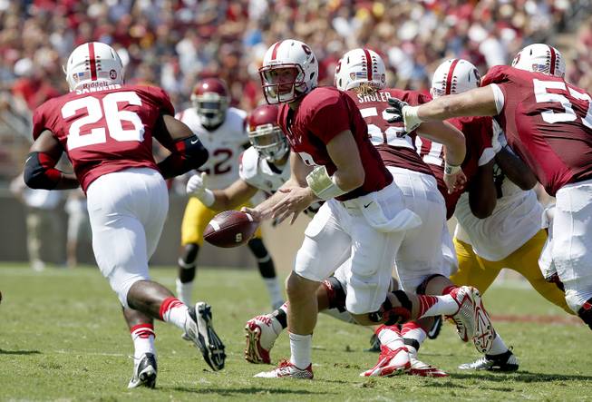 Stanford quarterback Kevin Hogan (8) hands off to running back Barry Sanders (26) against Southern California in a NCAA college football game on Saturday, Sept. 6, 2014, in Stanford, Calif. (AP Photo/Tony Avelar)
