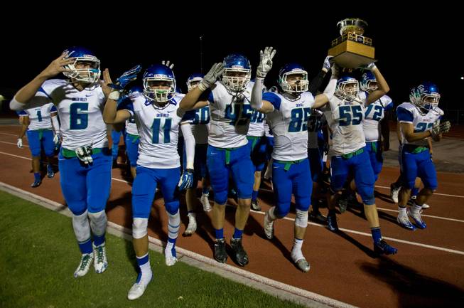 Green Valley players carry away the trophy after beating Basic 42-32 in the Henderson Bowl on Wednesday, October 2, 2014.