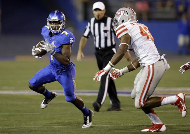San Jose State's Tyler Ervin, left, runs against UNLV's Najee Johnson (43) during the second half of an NCAA college football game Saturday, Oct. 4, 2014, in San Jose, Calif. 