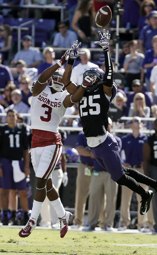 TCU cornerback Kevin White, right, breaks up a pass intended for Oklahoma wide receiver Sterling Shepard at Amon G. Carter Stadium on Saturday, Oct. 4, 2014, in Fort Worth, Texas.