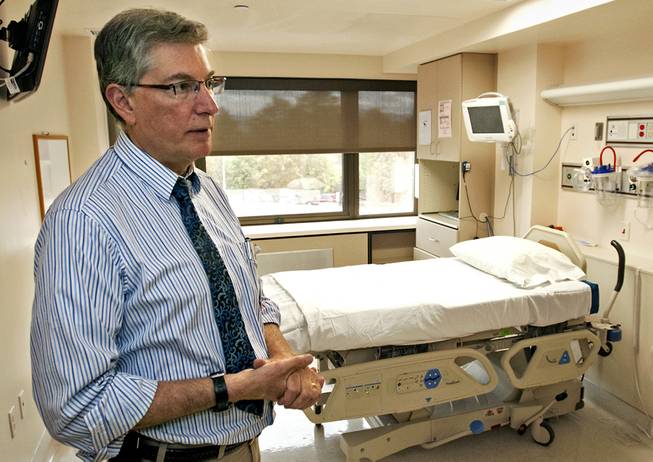 In this photo taken on Monday, Sept. 29, 2014, Dr. George Risi, an infectious disease specialist, shows one of St. Patrick Hospital’s three rooms in Missoula, Mont., that are equipped to handle infectious diseases like Ebola.