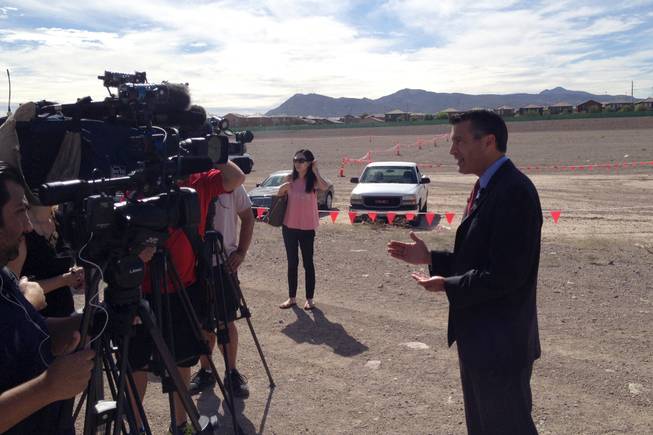 Gov. Brian Sandoval talking to reporters after a ceremonial groundbreaking of health care project Union Village on Wednesday, Oct. 8, 2014, at the project site on Galleria Drive at U.S. 95 in Henderson.