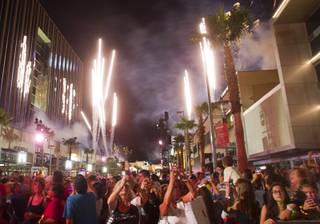 People photograph fireworks as Downtown Summerlin celebrates it's grand opening Thursday, Oct. 9, 2014. Grand opening events continue through Sunday.