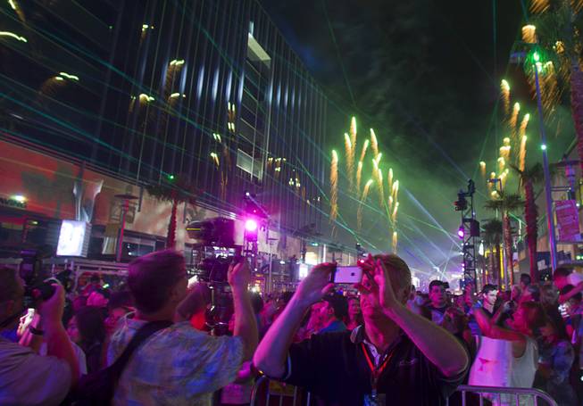 A man photographs fireworks on his cell phone as Downtown Summerlin celebrates it's grand opening Thursday, Oct. 9, 2014. Grand opening events continue through Sunday.
