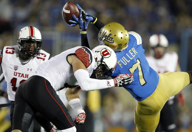Utah defensive back Brian Blechen, center, knocks the ball out of the hands of UCLA wide receiver Devin Fuller (7) on a pass play with linebacker Gionni Paul (13) looking on during the first half of an NCAA college football game Saturday, Oct. 4, 2014, in Pasadena, Calif.  (AP Photo/Alex Gallardo)