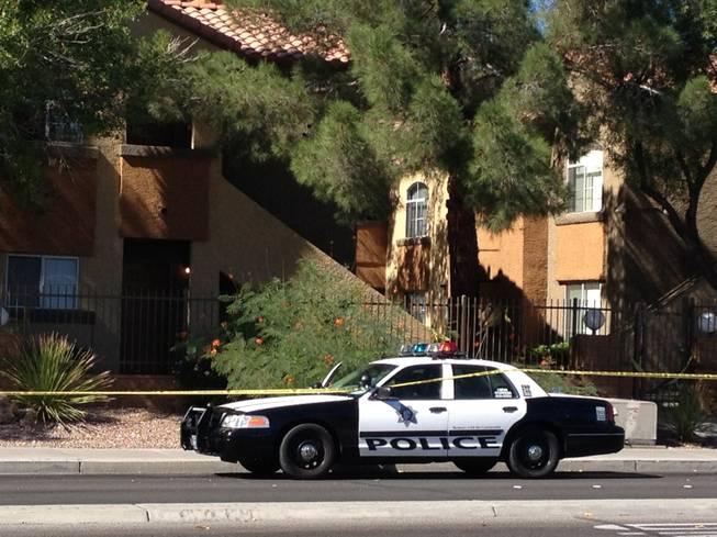 Police block off the area around the Oasis Vinings Apartments, where a man and a toddler were found dead Sunday morning, Oct. 12, 2014.
