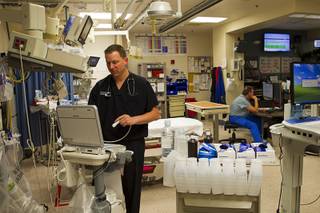 Dr. David Obert, left, is shown in the Trauma Unit at University Medical Center Wednesday, Oct. 8, 2014.