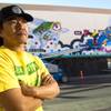 Artist Sush Machida poses by a mural he is creating with fellow artist Tim Bavington on the side of the Emergency Arts building at Fremont and Sixth streets in downtown Las Vegas Sunday, Oct. 12, 2014.