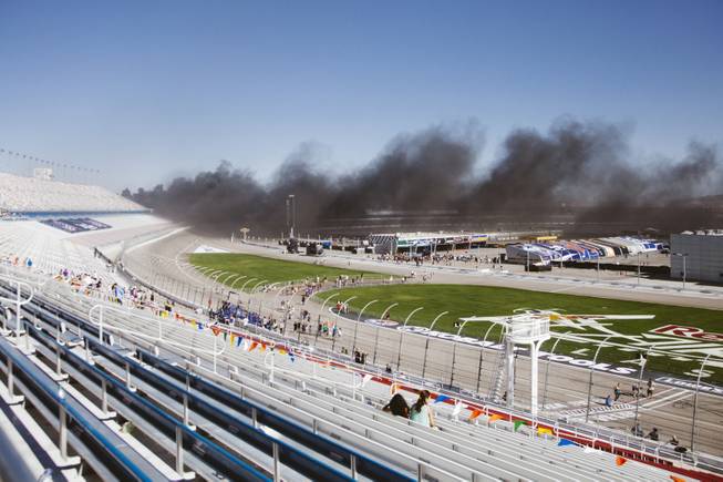 Black smoke bellows into the Las Vegas Motor Speedway after a truck caught fire during the Red Bull Air Race in the parking lot on October 12, 2014.