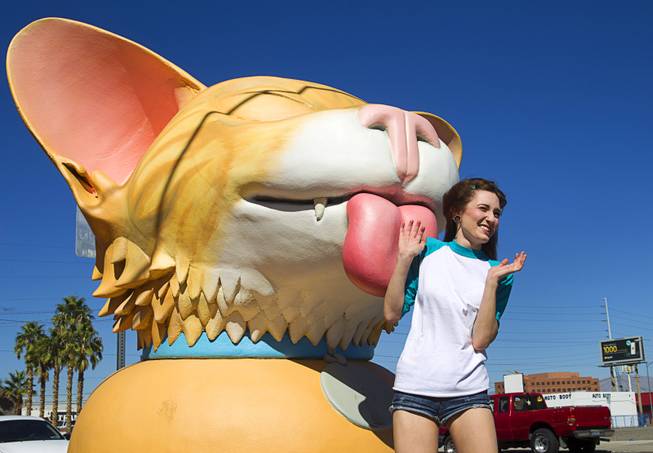 Gabriella Esposito, 18, poses by a kitten sculpture by Las Vegas artist Jesse Smigel at the corner of First Street and Coolidge Avenue in downtown Las Vegas Wednesday, Oct. 15, 2014.