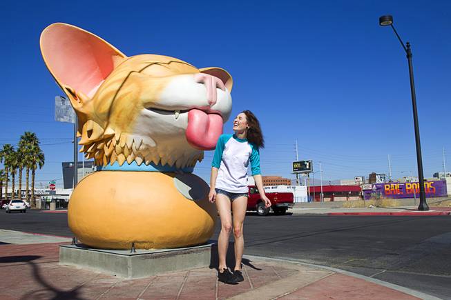 Gabriella Esposito, 18, poses by a kitten sculpture by Las Vegas artist Jesse Smigel at the corner of First Street and Coolidge Avenue in downtown Las Vegas Wednesday, Oct. 15, 2014.
