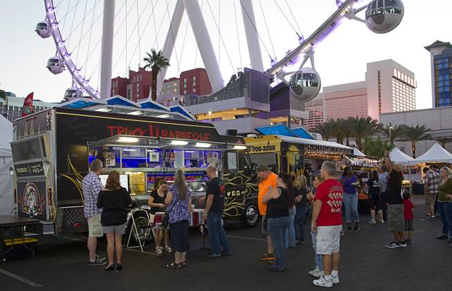People check out food trucks, like Truck U Barbeque, during the Las Vegas Foodie Fest in the Linq Promenade parking lot Thursday, Oct. 16, 2014. Truck U Barbeque is operated by celebrity chef Mike Minor.