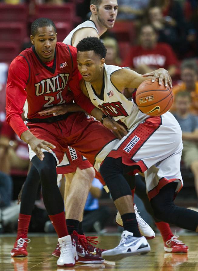 The UNLV basketball team players Jelan Kendrick #22 and Rashad Vaughn #1 fight for control during the scarlet and gray exhibition game at the Thomas & Mack Center on Thursday, October 16, 2014. .